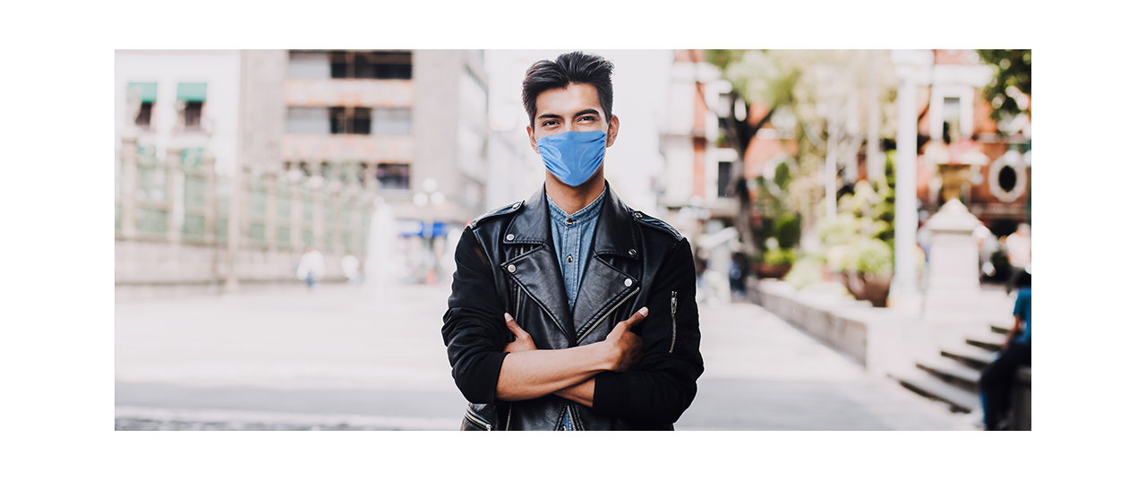 Latino man with surgical mask and arms crossed