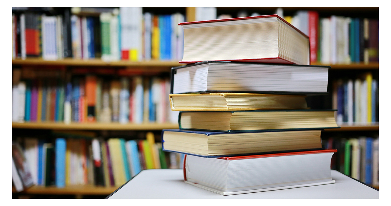 Stack of books on a table in a library